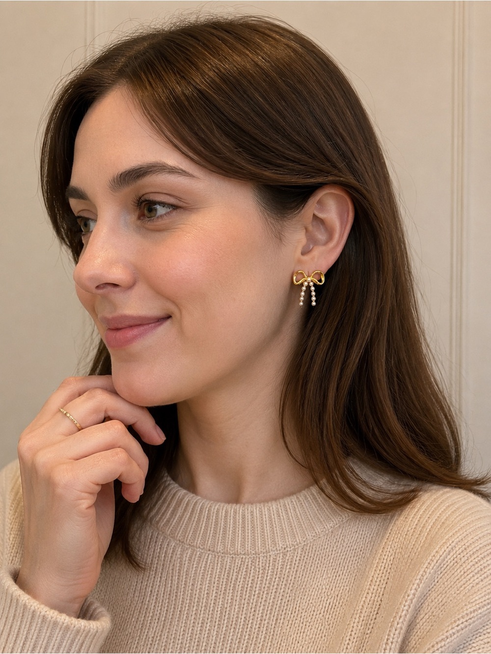 Gold bow with pearl stud earrings